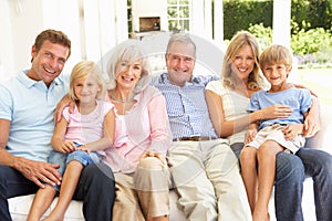 Extended Family Relaxing Together On Sofa