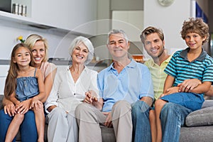 Extended family sitting on couch in living room