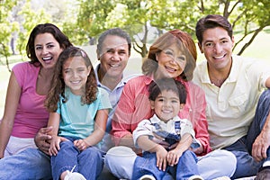 Extended family sitting outdoors smiling photo