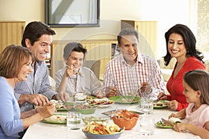 Extended Hispanic Family Enjoying Meal At Home photo