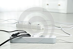 Extension cords on floor indoors. Electrician`s professional equipment