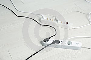 Extension cords on floor, space for text. Electrician`s equipment