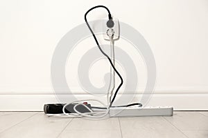 Extension cords with power plugs in socket. Electrician`s professional equipment