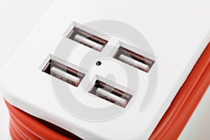 Extension Socket with USB Port on white background for charging phones and electronic devices, red power cord