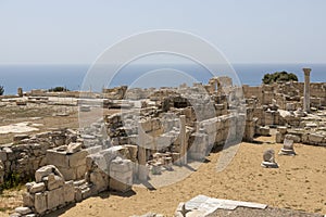 The extensive ruins of Kourion, with columns and remnants of ancient structures, set against the Mediterranean Sea