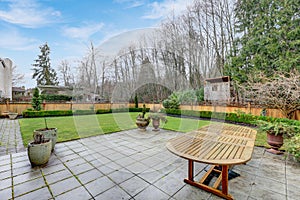 Exterior of American Colonial home with well kept backyard