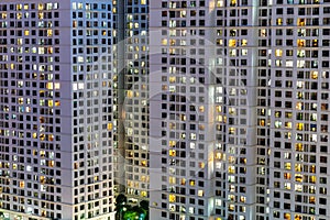 Exterior of apartment building at night with light from windows