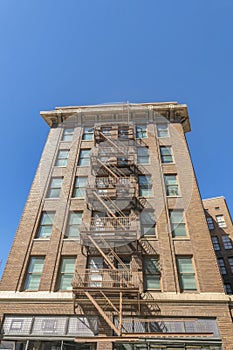 Exterior of an apartment with flight of stairs for fire exit against blue sky