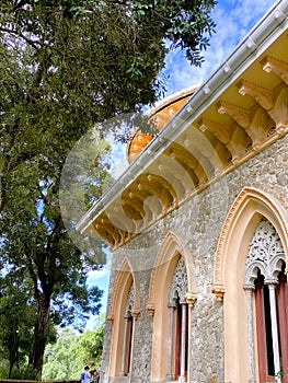 Exterior architectural details of a mansion lined with flowers and plants