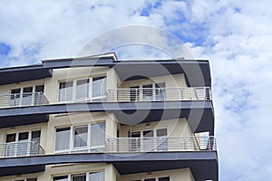 Exterior of beautiful building with balconies against blue sky, low angle view