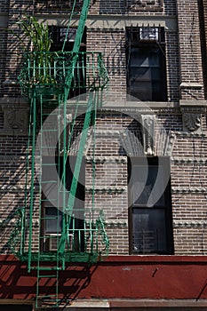 Exterior of a Beautiful Old Apartment Building on the Lower East Side of New York City with a Green Fire Escape and Ladder