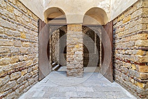 Exterior brick stone passage with two adjacent vaulted opened wooden grunge doors