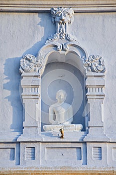 Exterior of the Buddha statue at Ruwanwelisaya stupa in Anuradhapura, Sri Lanka.