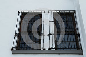 Exterior of building with beautiful window and steel grilles, low angle view