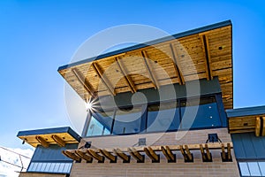 Exterior of a building with red brick wall and flat roof against vivid blue sky