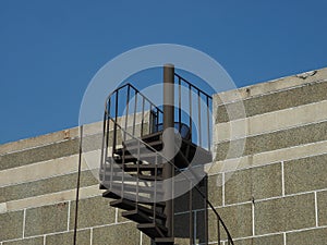 Exterior cantilevered metal spiral staircase photo