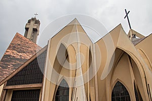 Exterior of Catholics church in Abuja with arches, crosses, decorative walls, church is known as The National Christian Centr photo