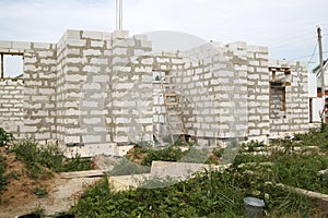 exterior of a country house under construction. Site on which th