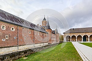 Exterior courtyard with part of Alden Biesen Castle surrounded by moat