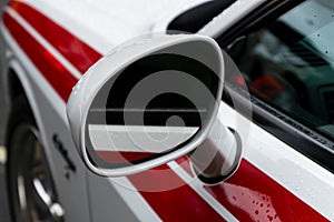 Exterior details of a luxury car. The car side mirror close-up