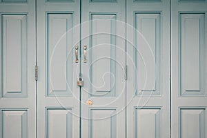 Exterior door with handle and lock in vintage style for background.