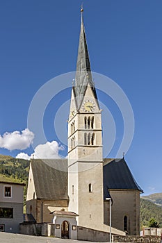 The exterior of the Evangelical Church Reformierte Kirche in Santa Maria Val MÃ¼stair, Switzerland, on a sunny day