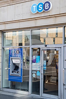 Exterior facade of TSB Trustees Savings Bank brancj showing entrance door, atm cash point and company logo