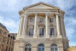 Exterior facade of Versailles Palace. Detail of visitors main entrance. France