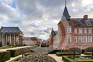 Exterior of former 16th century Alden Biesen castle, garden with bushes and small trees