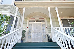 Exterior, front entrance looking up stairs on old Victorian home