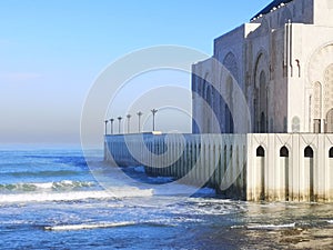 Exterior of Hassan II Mosque by the sea with blue sky in Casablanca, Morocco