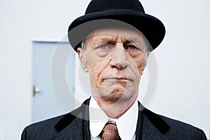 Exterior headshot of a senior man with hat