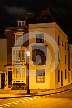 the exterior of a home from the 1700's lit by a street lamp in Old portsmouth, Portsmouth, UK