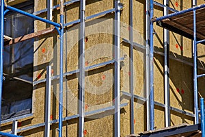 Exterior house wall heat insulation with mineral wool, building under construction