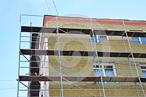 Exterior house wall heat insulation with mineral wool, building under construction.