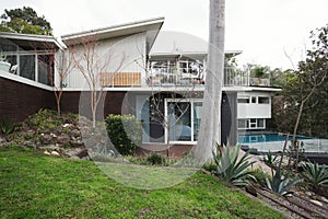 Exterior of a large mid century modern Australian home with pool