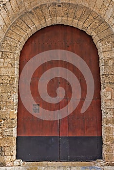 Exterior of Large Old Wooden Arched Door in Spain
