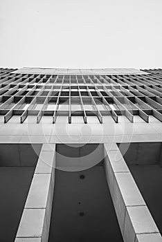 A exterior look from under the building in black and white