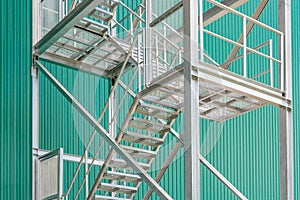 Exterior metal staircase with handrails at a industrial building