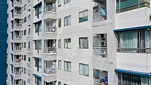 Exterior of a modern high-rise multi-story apartment building condo - facade, windows and balconies