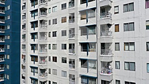 Exterior of a modern high-rise multi-story apartment building condo - facade, windows and balconies