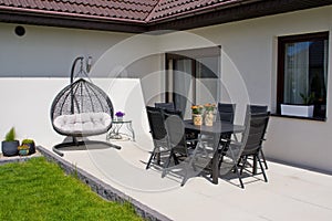 Exterior of modern house terrace with swinging chair or summer seat