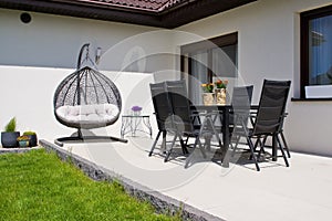 Exterior of modern house terrace with swinging chair or summer seat
