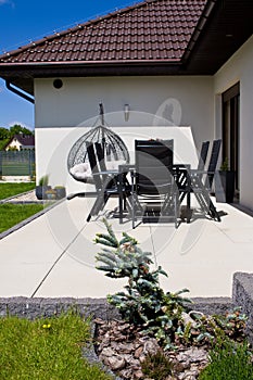 Exterior of modern house terrace with swinging chair or summer seat