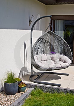 Exterior of modern house terrace with swinging chair or summer seat