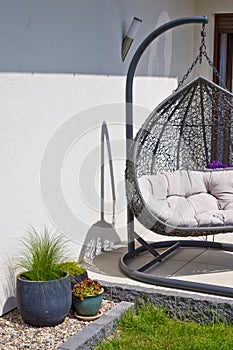 Exterior of modern house terrace with swinging chair or summer seat