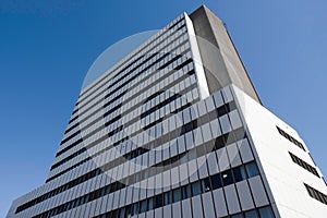 Exterior of a modern office building made of glass and plastic and concrete panels