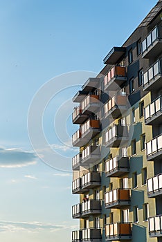 Exterior of modern residential apartment building with balconies on housing estate. Urban landscape with block of flats.
