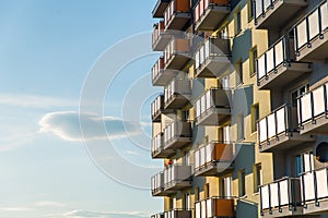 Exterior of modern residential apartment building with balconies on housing estate. Urban landscape with block of flats.