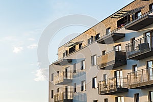 Exterior of modern residential apartment building with balconies on housing estate.